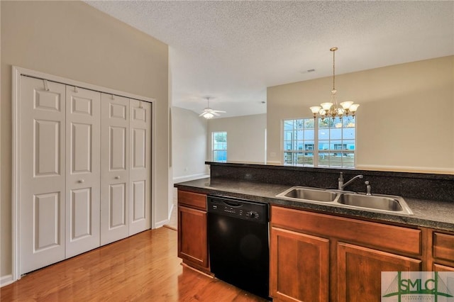 kitchen with sink, dishwasher, hanging light fixtures, a textured ceiling, and light wood-type flooring