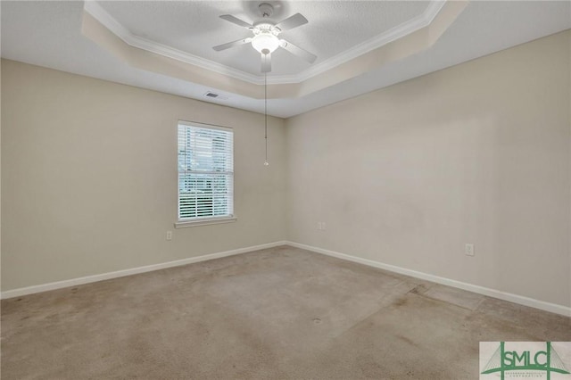 carpeted spare room featuring a raised ceiling, crown molding, a textured ceiling, and ceiling fan