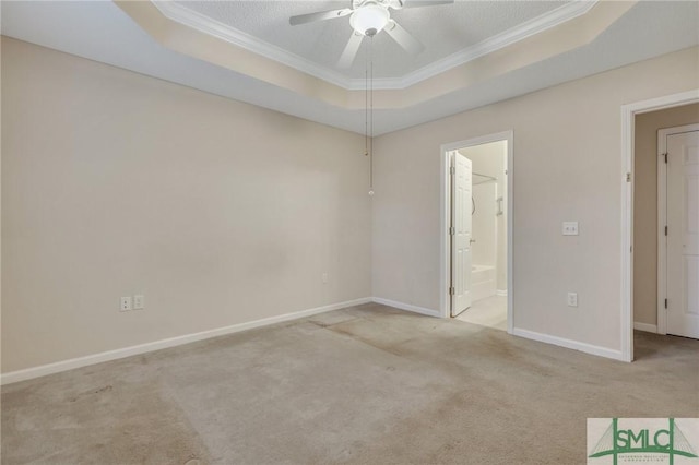 carpeted spare room featuring crown molding, a textured ceiling, ceiling fan, and a tray ceiling