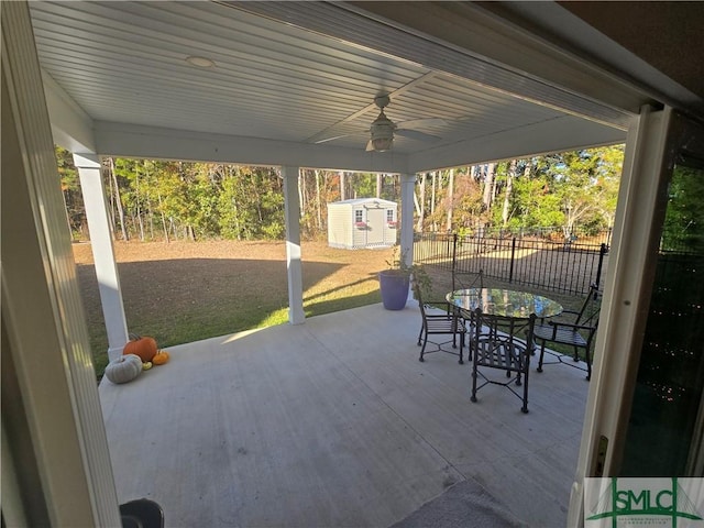 view of patio / terrace with ceiling fan and a storage shed