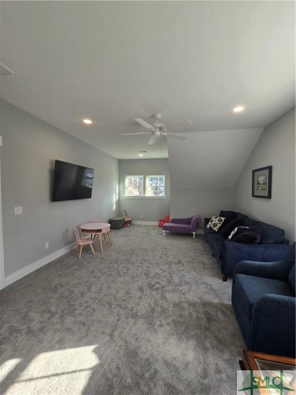 living room with vaulted ceiling, carpet flooring, and ceiling fan