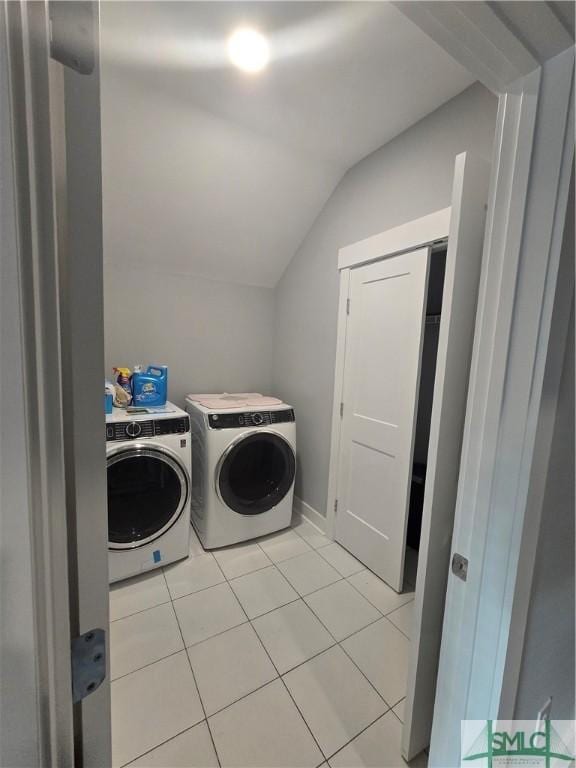 clothes washing area featuring separate washer and dryer and light tile patterned flooring