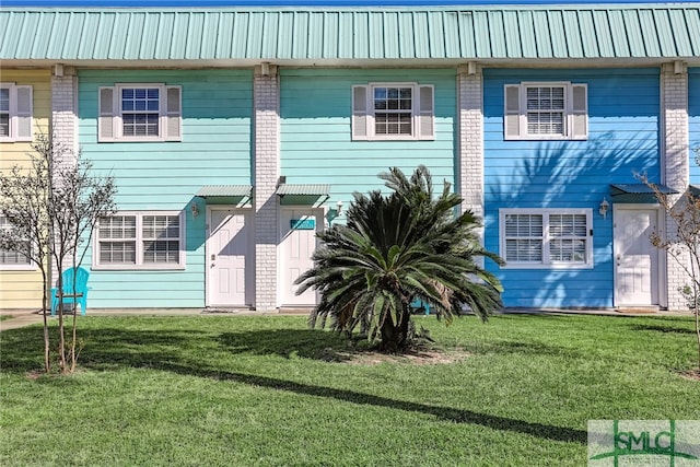 rear view of property featuring a yard