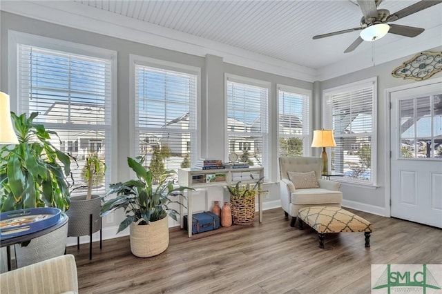 sunroom featuring ceiling fan