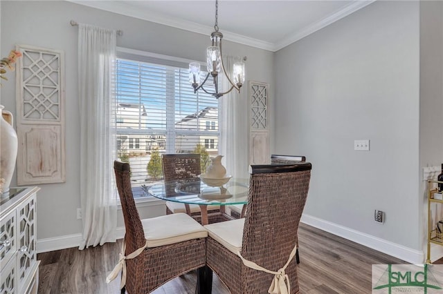 dining room with crown molding, dark hardwood / wood-style floors, and a chandelier