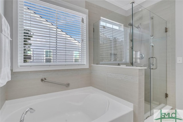 bathroom with plenty of natural light and shower with separate bathtub