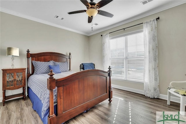 bedroom featuring wood-type flooring, ceiling fan, and crown molding