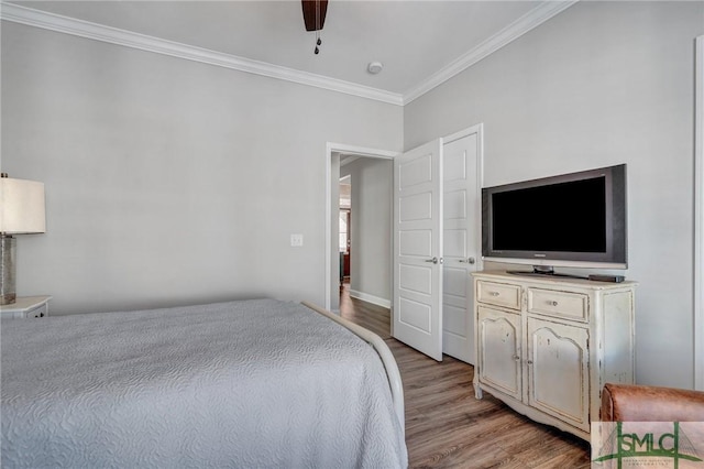 bedroom with ornamental molding, ceiling fan, and light wood-type flooring