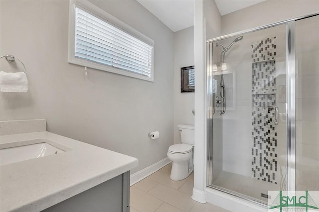 bathroom with vanity, a shower with shower door, tile patterned floors, and toilet