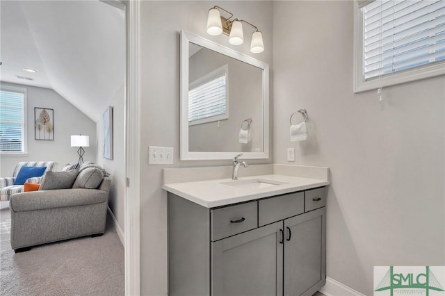 bathroom with vanity and vaulted ceiling