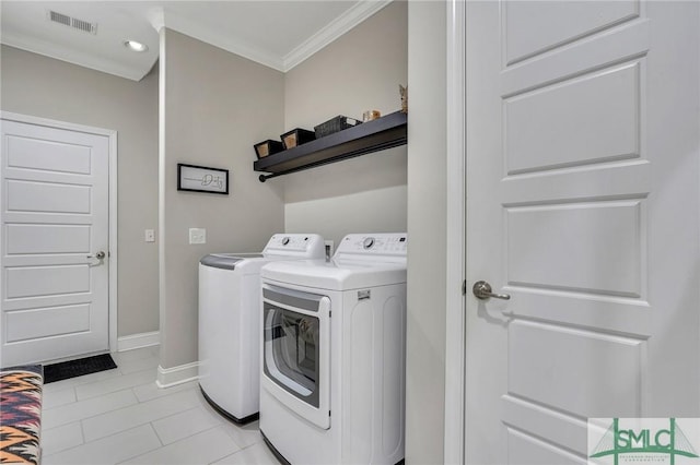 laundry area featuring washing machine and dryer, light tile patterned flooring, and crown molding