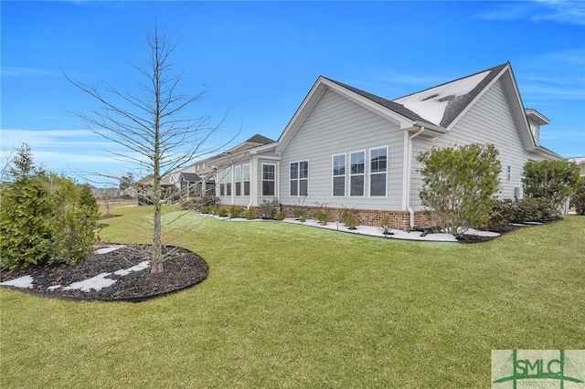 rear view of house with a yard