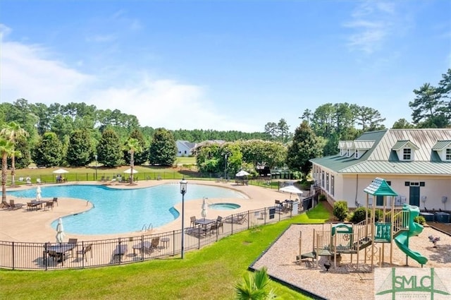 view of pool featuring a playground, a yard, and a patio area