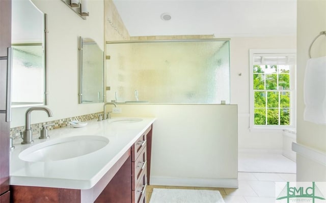 bathroom featuring vanity, tile patterned floors, and a shower