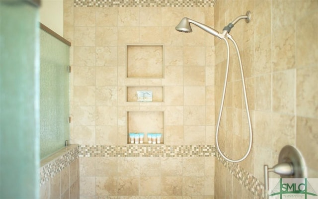 bathroom with tiled shower