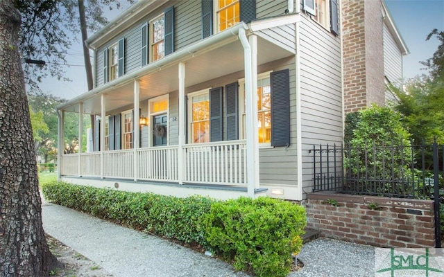 view of property exterior with covered porch