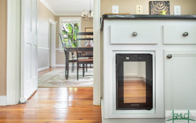 interior details with crown molding and hardwood / wood-style floors