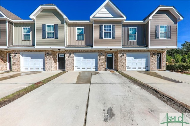 townhome / multi-family property featuring a garage