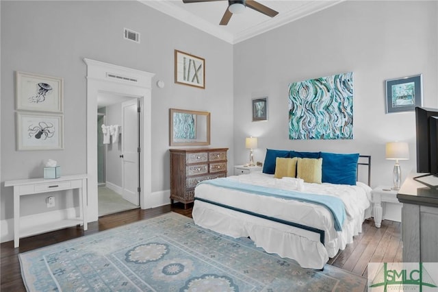 bedroom with ensuite bathroom, dark hardwood / wood-style floors, a high ceiling, ceiling fan, and crown molding