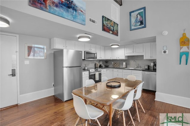 kitchen with white cabinetry, appliances with stainless steel finishes, sink, and decorative backsplash