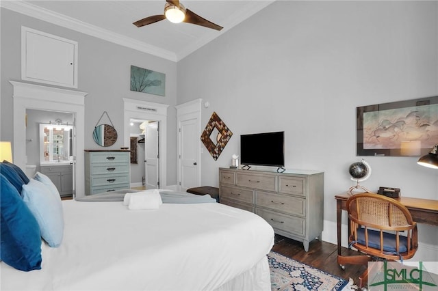 bedroom featuring connected bathroom, dark wood-type flooring, ornamental molding, and a high ceiling