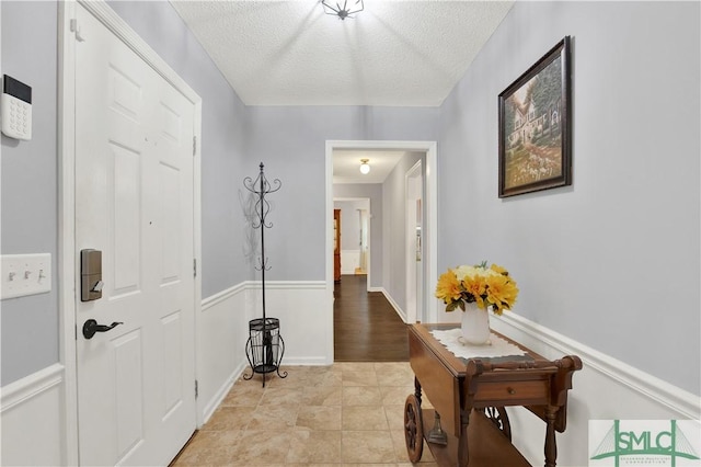 interior space with light tile patterned floors and a textured ceiling