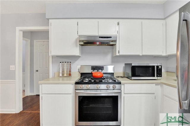 kitchen with white cabinetry, appliances with stainless steel finishes, and dark hardwood / wood-style floors