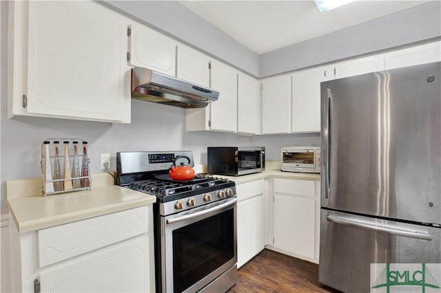 kitchen featuring stainless steel appliances, dark hardwood / wood-style flooring, and white cabinets