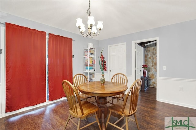 dining room featuring dark wood-type flooring and a chandelier