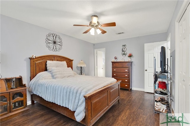 bedroom with ceiling fan, dark hardwood / wood-style flooring, and a closet