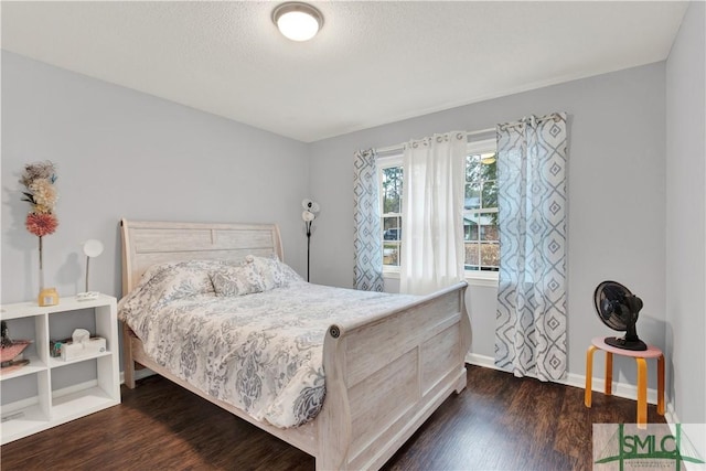 bedroom with dark wood-type flooring and a textured ceiling