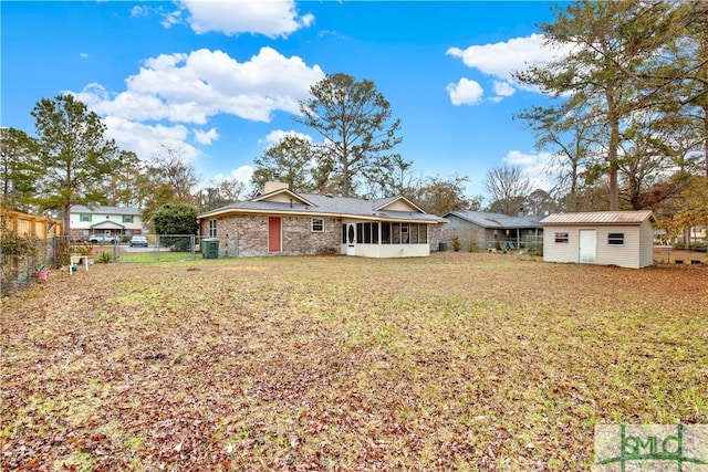 rear view of house with a yard and a shed