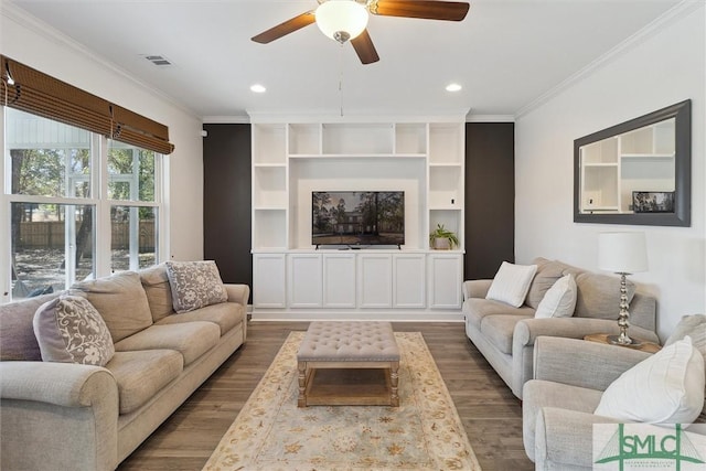 living room featuring built in features, ornamental molding, and dark hardwood / wood-style floors