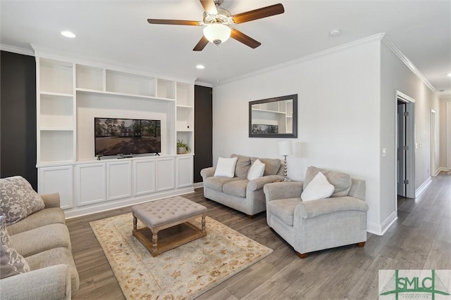 living room with crown molding, dark hardwood / wood-style floors, and ceiling fan