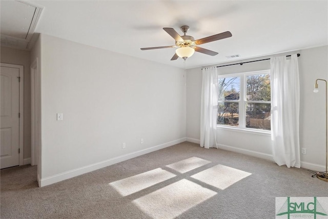 spare room with light colored carpet and ceiling fan