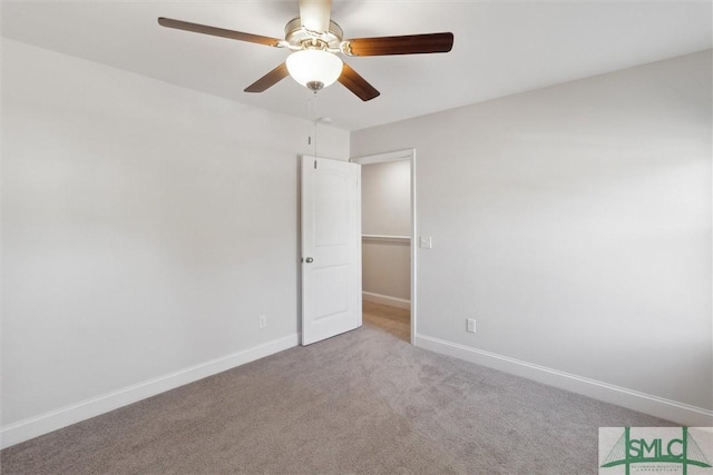 carpeted spare room with ceiling fan