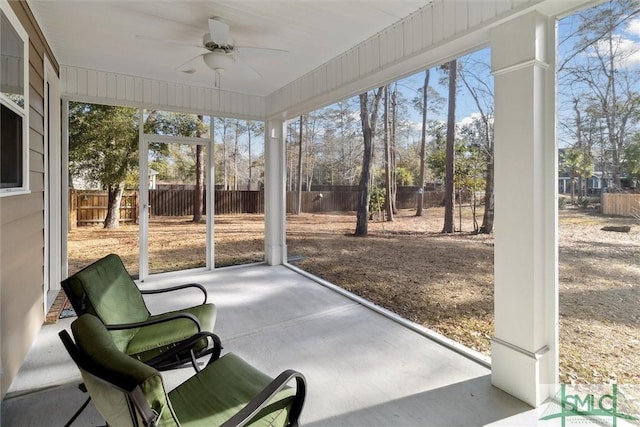 sunroom / solarium featuring ceiling fan