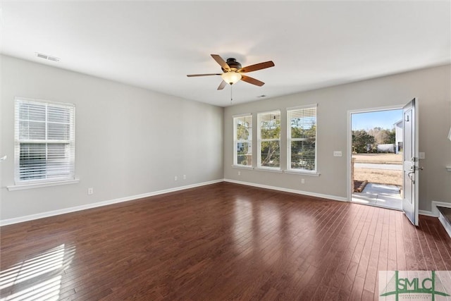 unfurnished room featuring dark wood-type flooring and ceiling fan