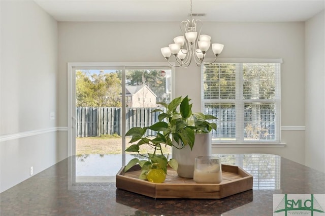 interior space with a chandelier and a healthy amount of sunlight