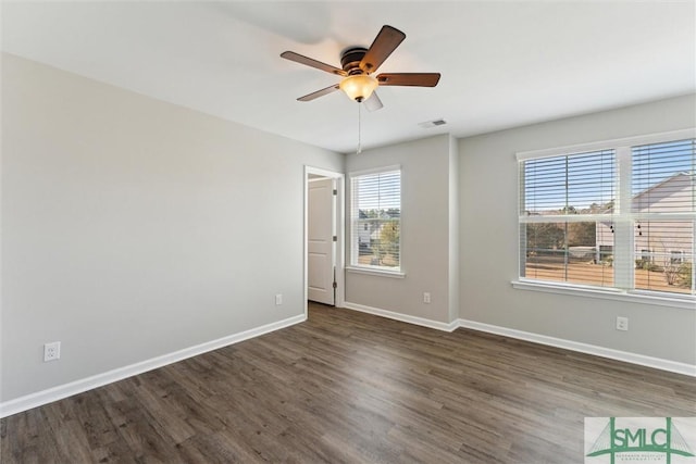 spare room with ceiling fan and dark hardwood / wood-style floors