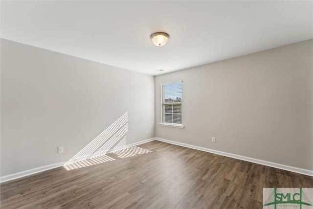 spare room featuring dark hardwood / wood-style flooring