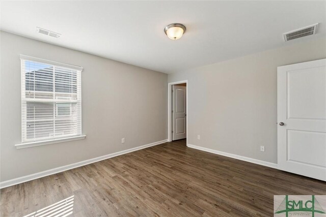 spare room featuring dark hardwood / wood-style flooring