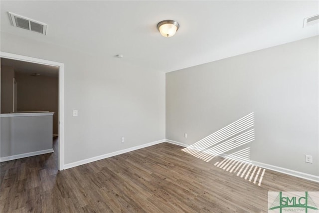 spare room featuring dark wood-type flooring