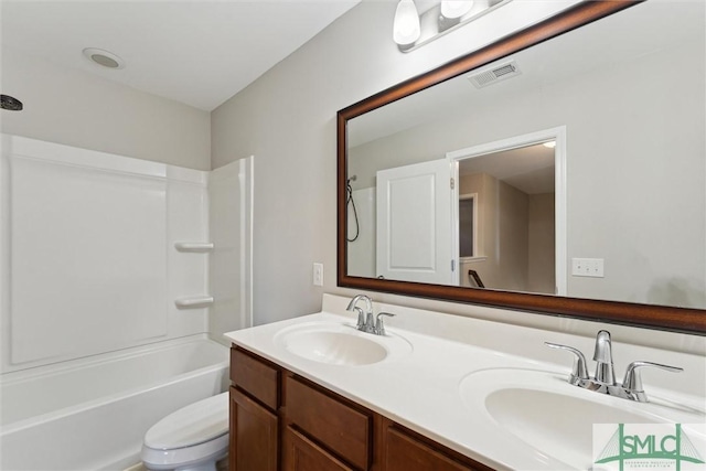 full bathroom featuring vanity, bathtub / shower combination, and toilet