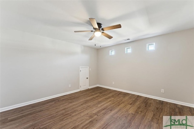 empty room featuring ceiling fan and dark hardwood / wood-style flooring