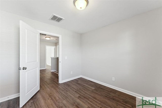 unfurnished room featuring dark hardwood / wood-style floors