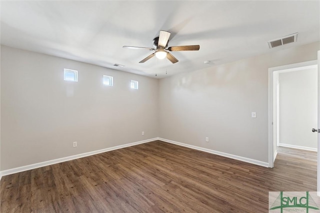 unfurnished room with ceiling fan and dark hardwood / wood-style flooring