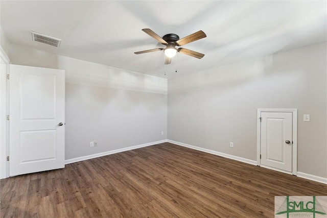 unfurnished room with ceiling fan and dark hardwood / wood-style flooring