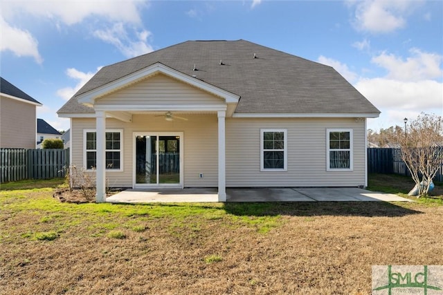 back of house featuring a lawn, ceiling fan, and a patio area