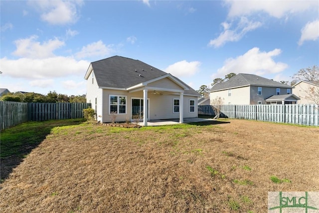 rear view of house featuring a patio and a yard